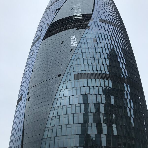 Soho 5G Exhibition Hall reference: curved glass façade of the high-rise seen from below