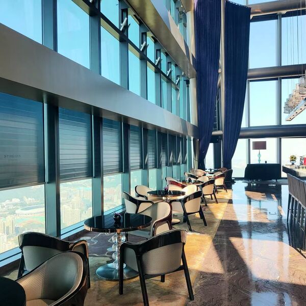 Bar and lounge at The St. Regis Shenzhen with roller shades in front of floor-to-ceiling glazing