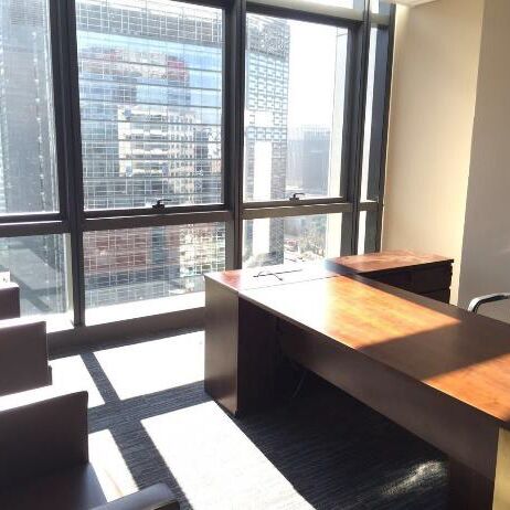 Office at the Asian Infrastructure Investment Bank before the RHODESHADE installation, with direct sunlight