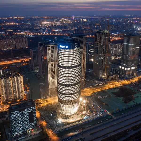 Soho 5G Exhibition Hall reference: illuminated high-rise in Beijing's night-time cityscape