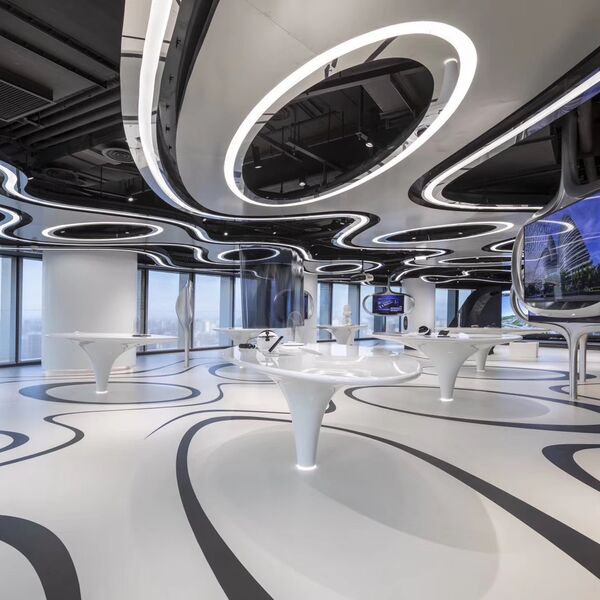 Soho 5G Exhibition Hall: white exhibition space with organically shaped display tables and window front