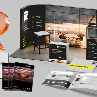 The new RHODETEC corporate design on a trade fair stand, brochures and stationery