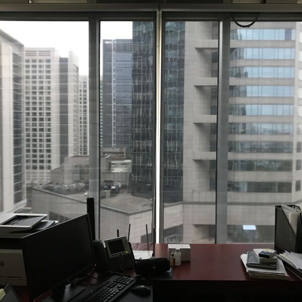 Workplace at China Development Bank with roller shades along the window front