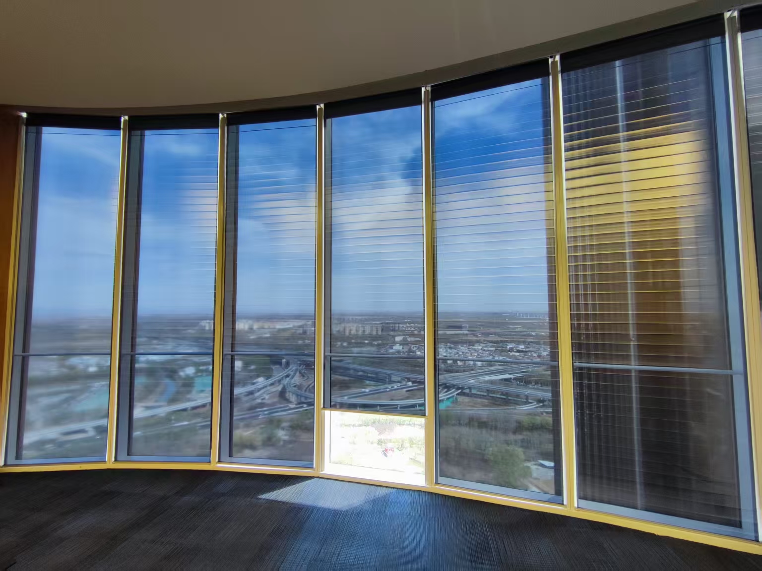 AVIC Headquarters in Beijing: curved window front with roller shades and a view over the city