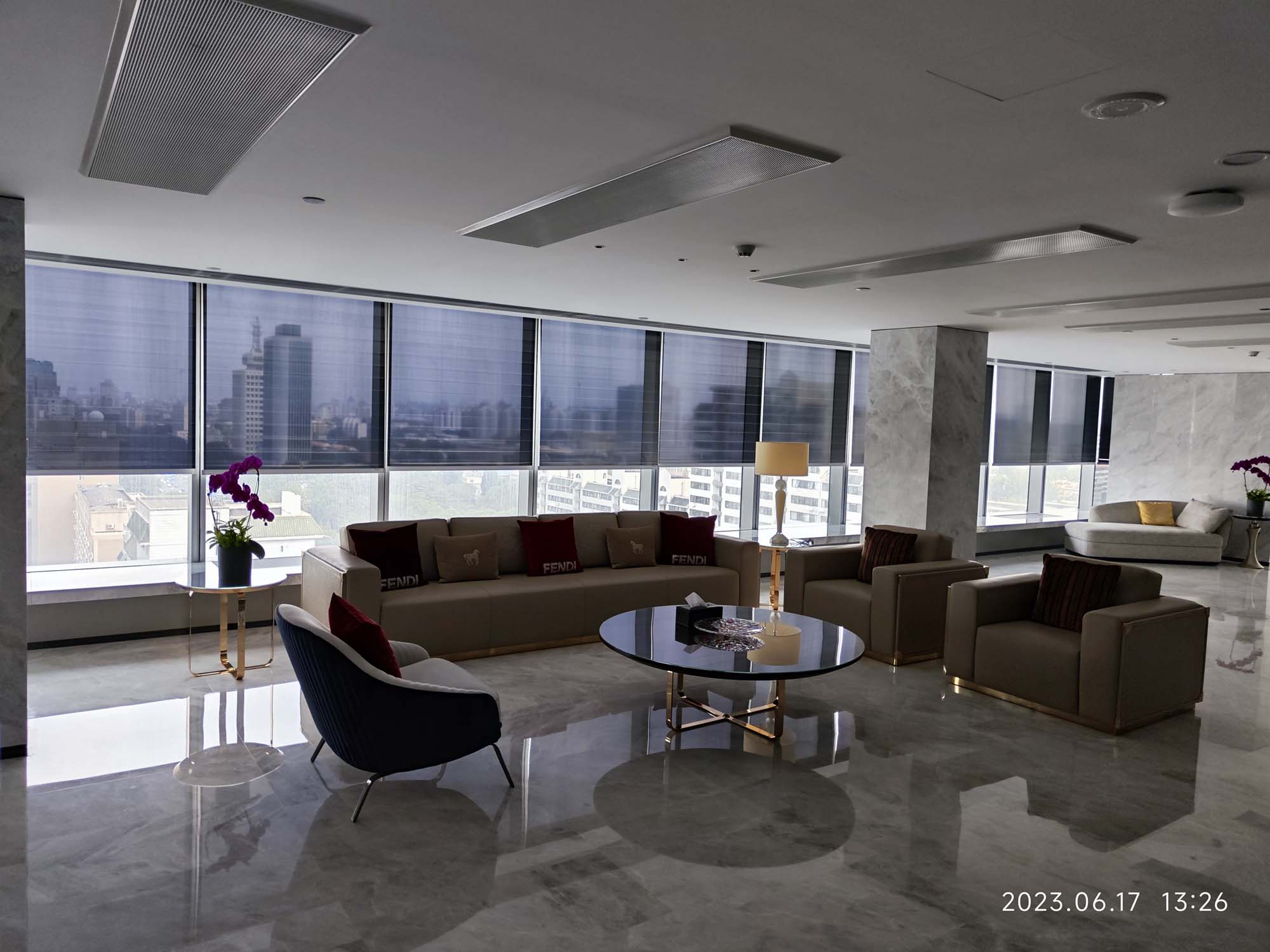 Lobby of Beijing Shiji Information Headquarters with seating area and roller shades along the windows