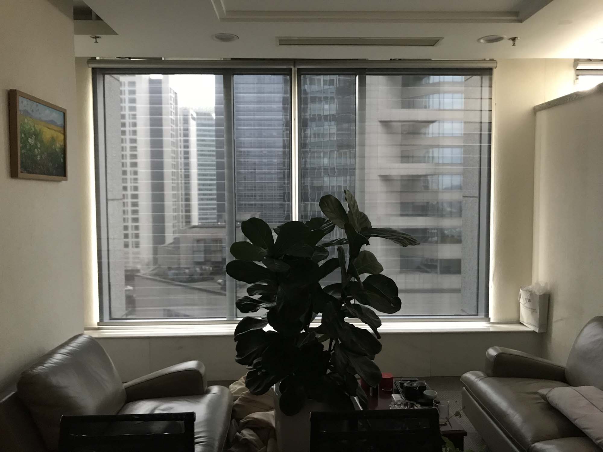 Office at China Development Bank in Beijing with a roller shade at the window