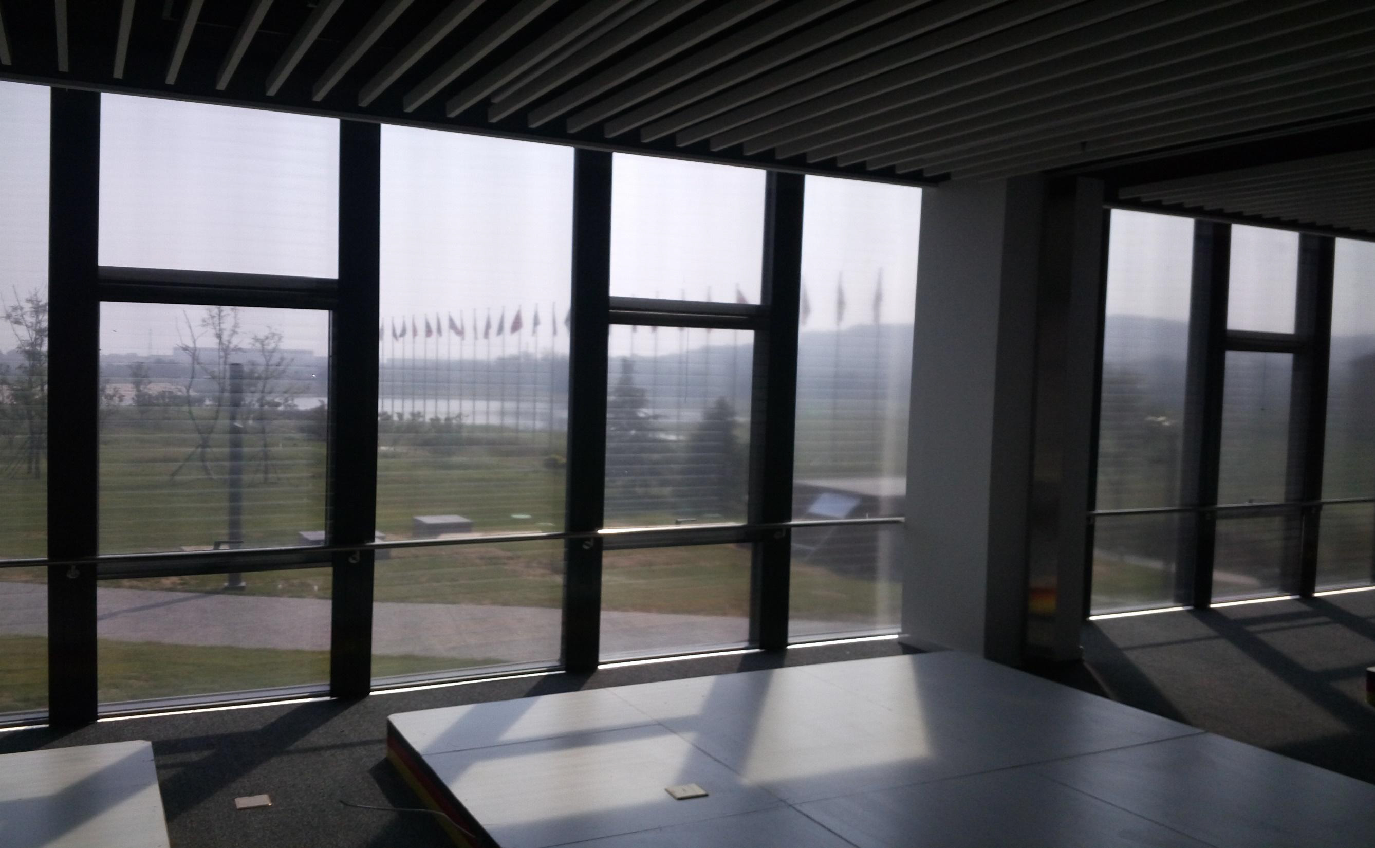 Interior of the SINO-German ECO Center in Qingdao with roller shades along the window front